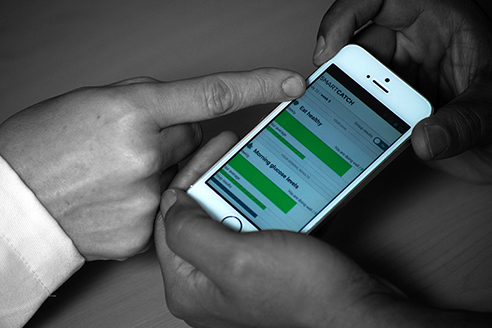 Two sets of hands using a smart phone Two sets of hands using a smart phone